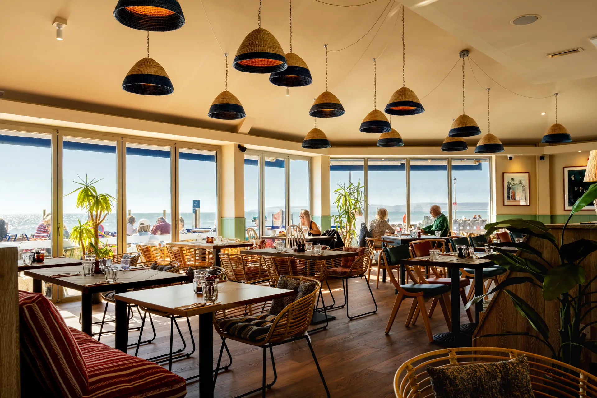 Dining room with tables by the sea-facing windows